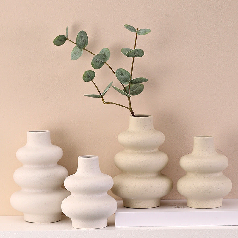 Nordic ceramic gourd vase on an entryway console with a wooden tray